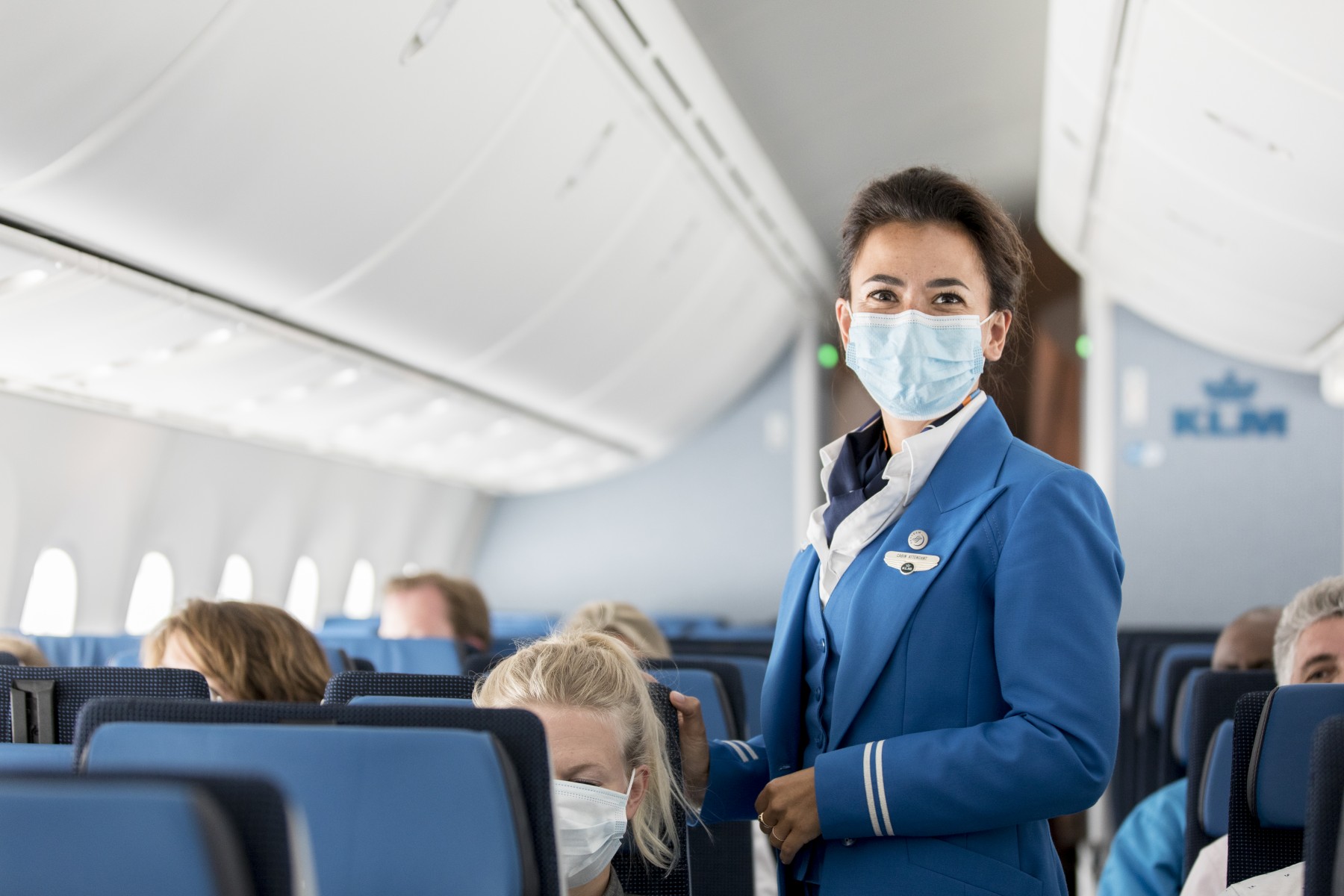 a woman wearing a mask on an airplane