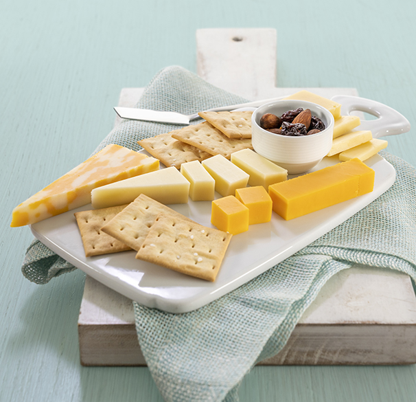 a plate of cheese crackers and nuts