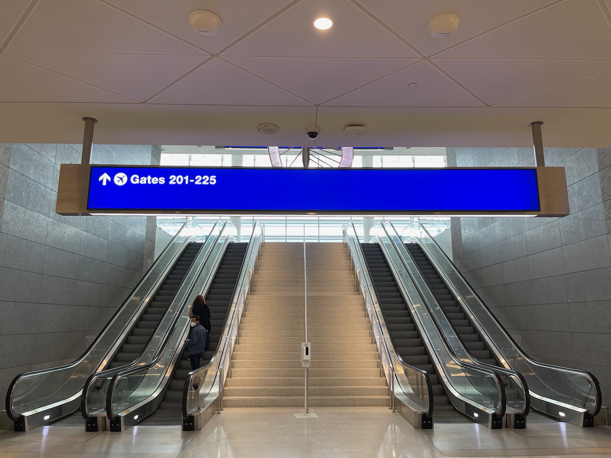 a blue sign above a staircase