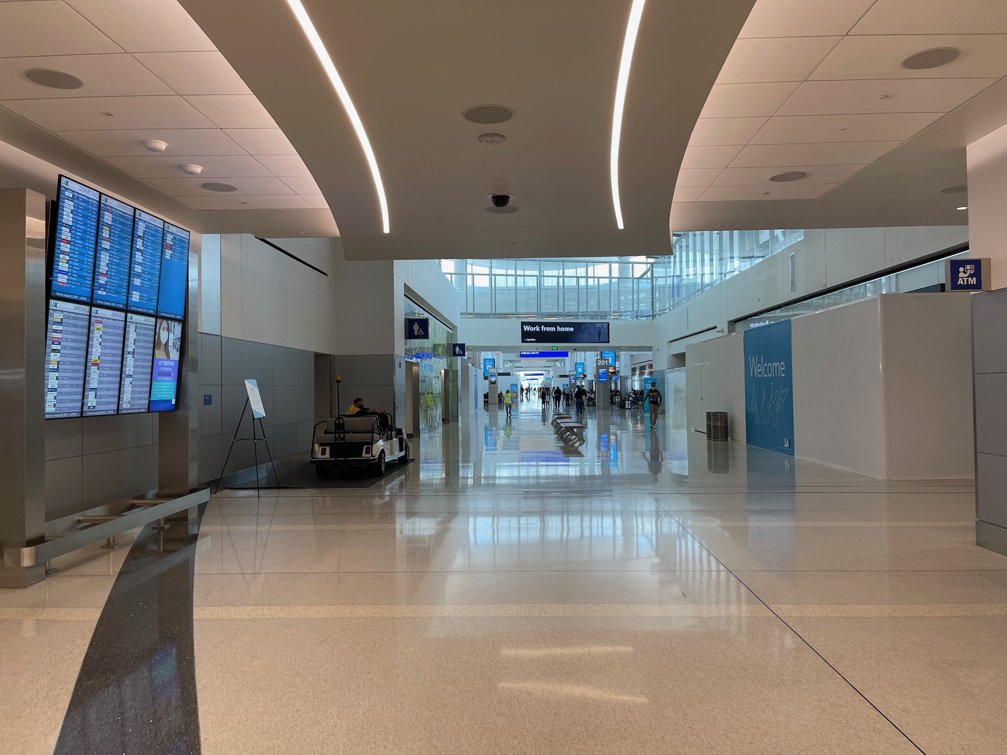 a large hall with people walking in it