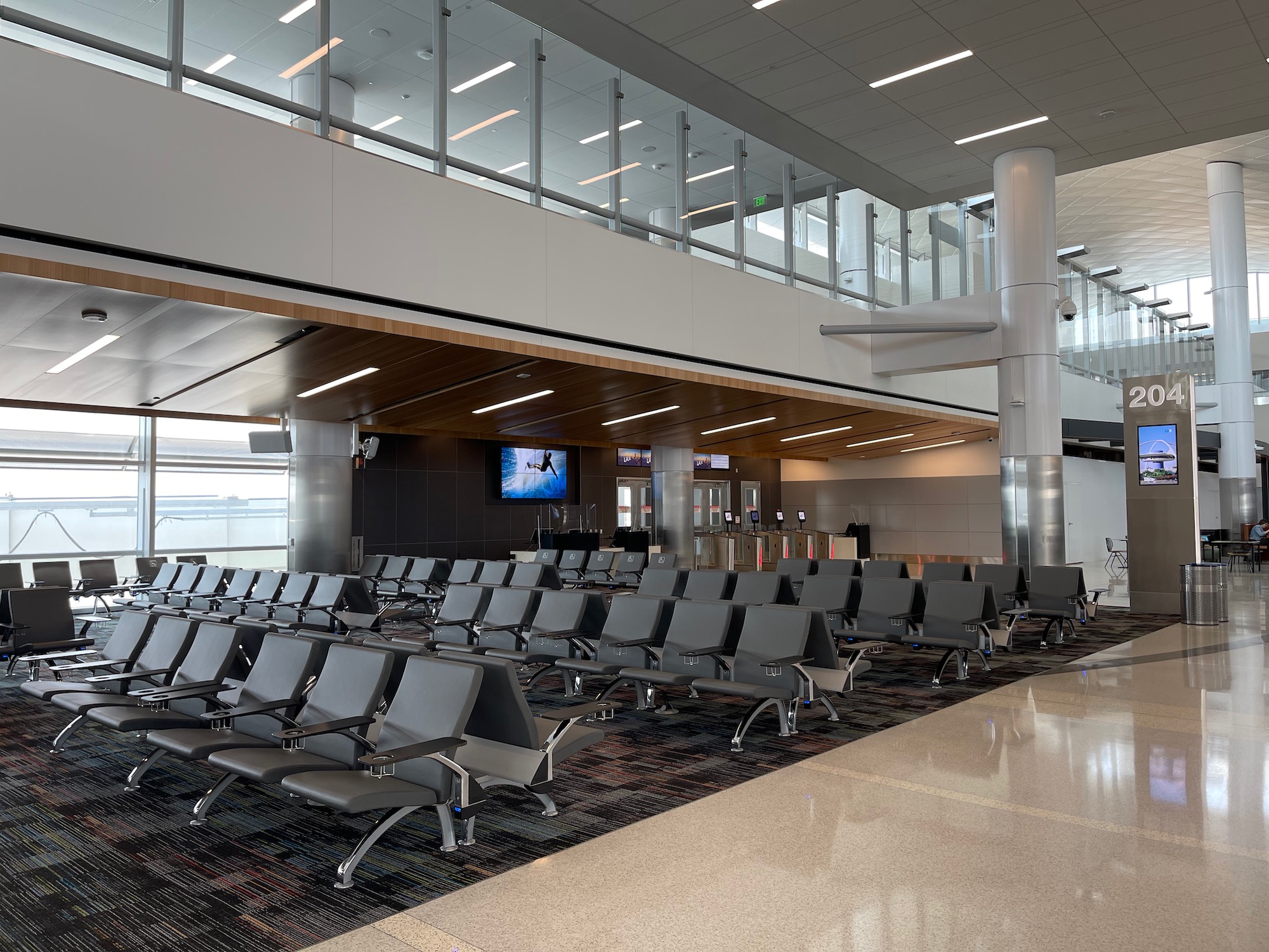 a large airport lounge with rows of chairs