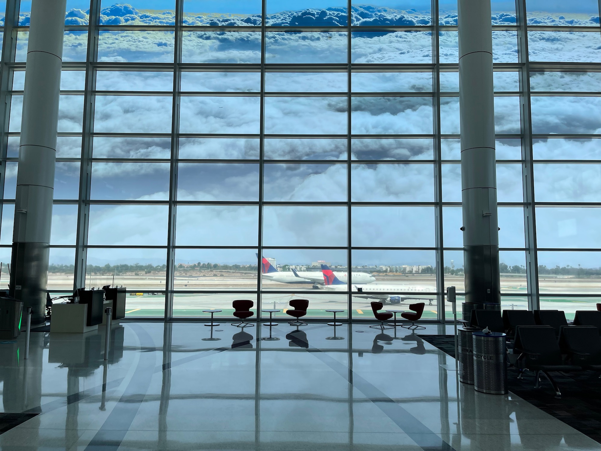a large glass window with a view of an airplane and runway