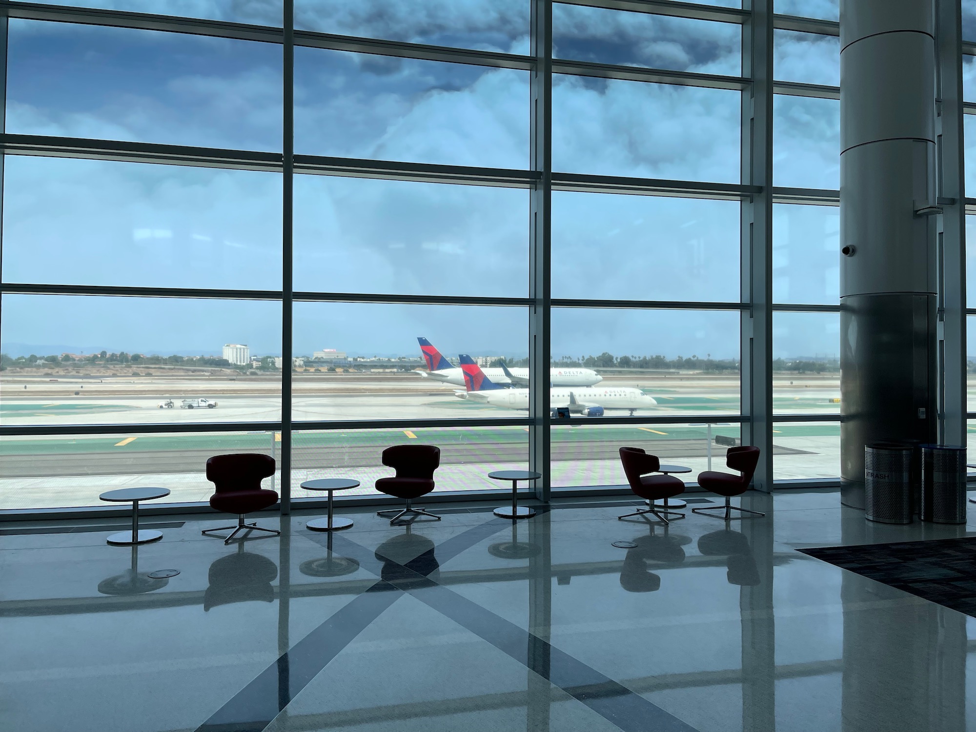 a large glass window with a plane in the background