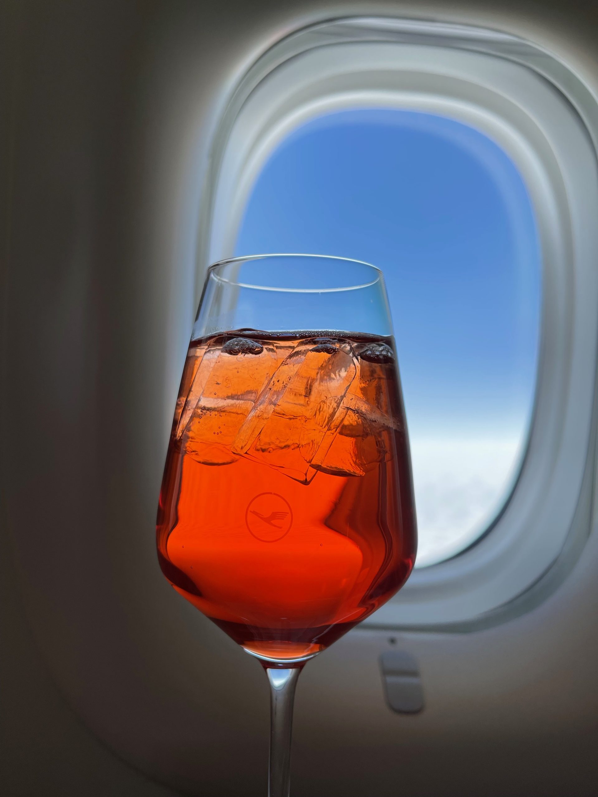 a glass of liquid with ice in it