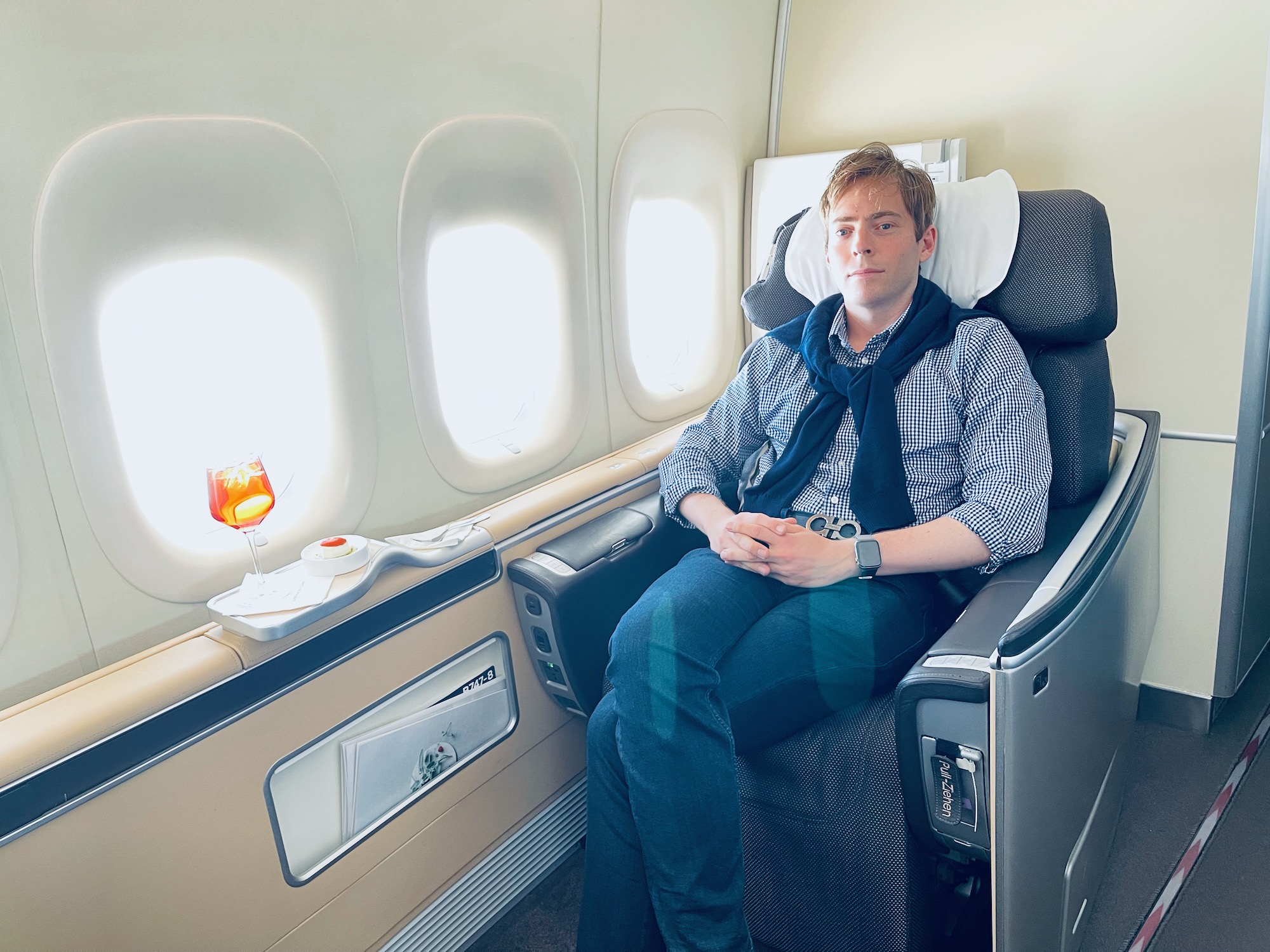 a man sitting in a chair on an airplane