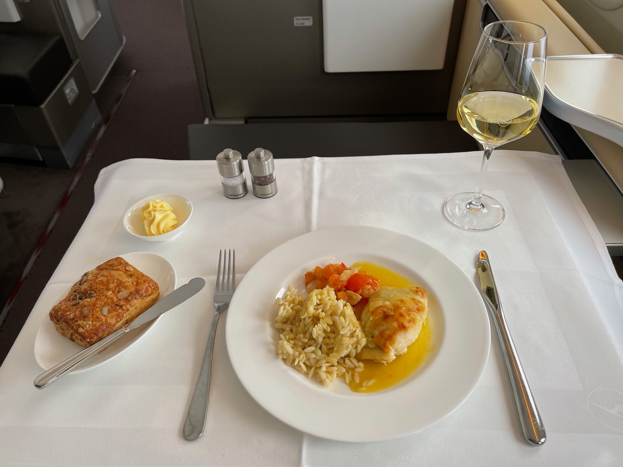 a plate of food and a glass of wine on a table