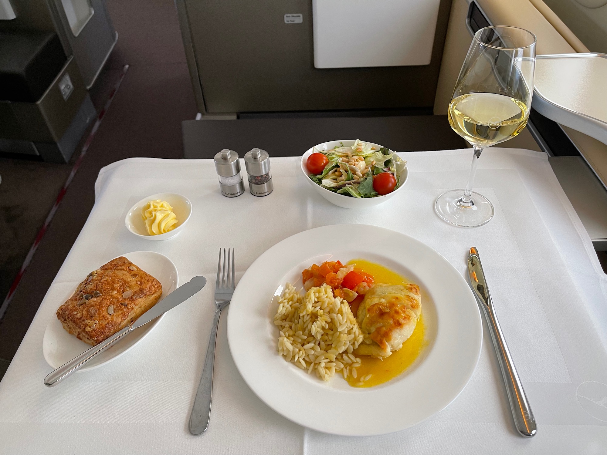 a plate of food and a glass of wine on a table