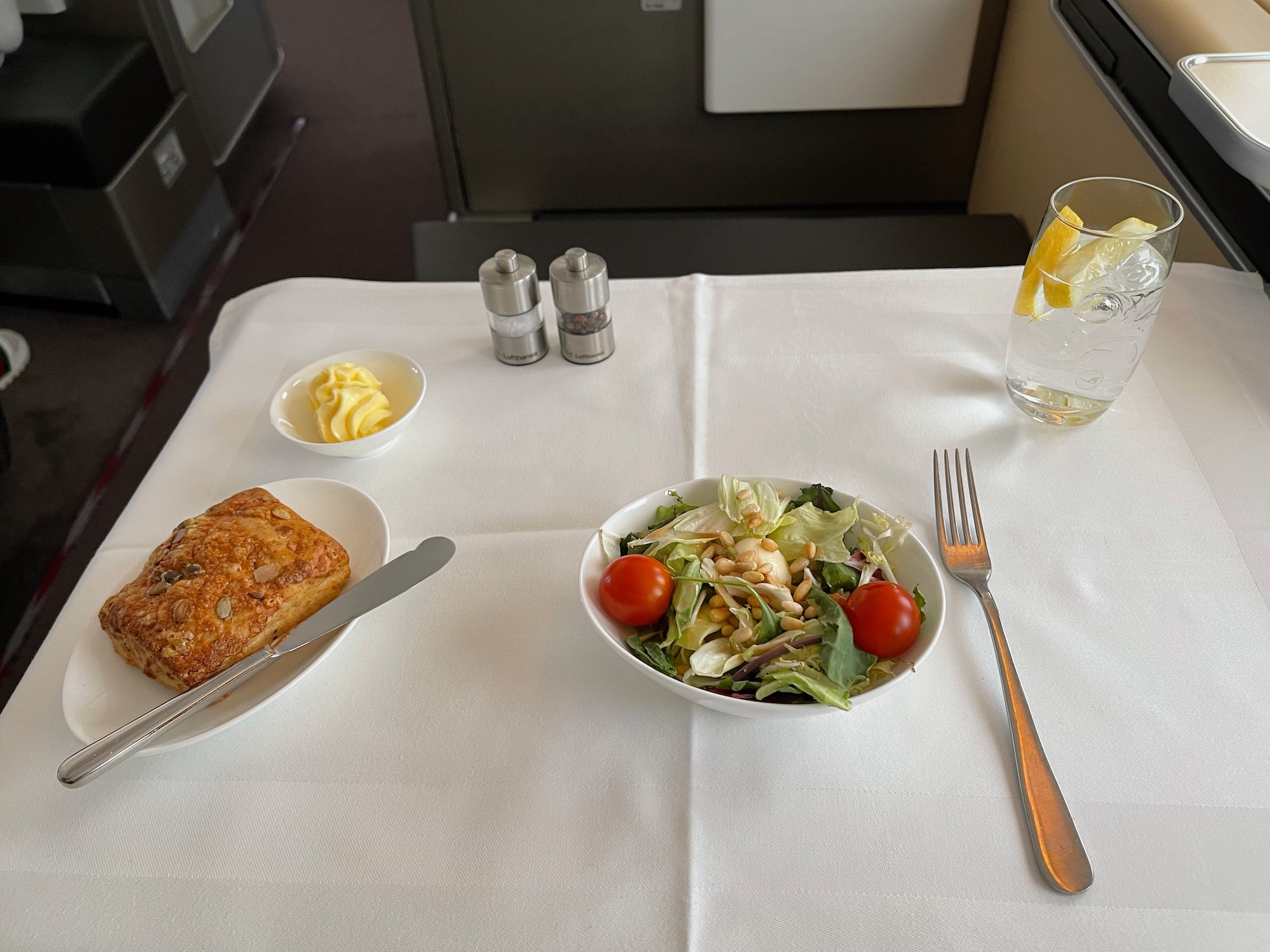 a plate of salad and bread on a table