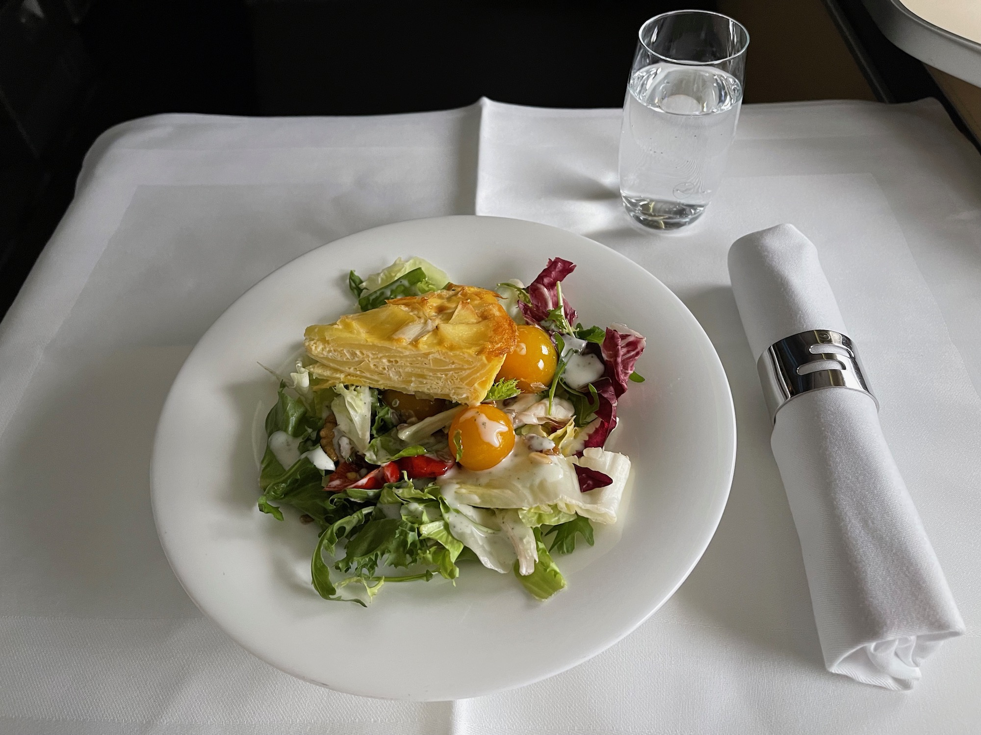 a plate of salad and a glass of water