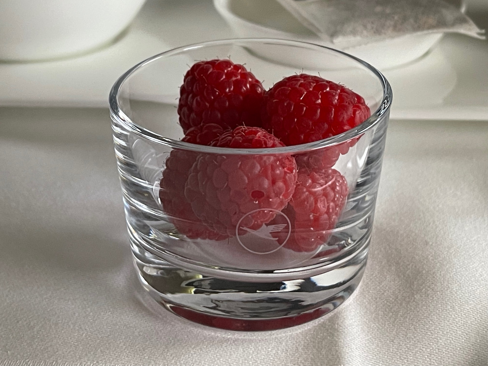 a glass with raspberries in it