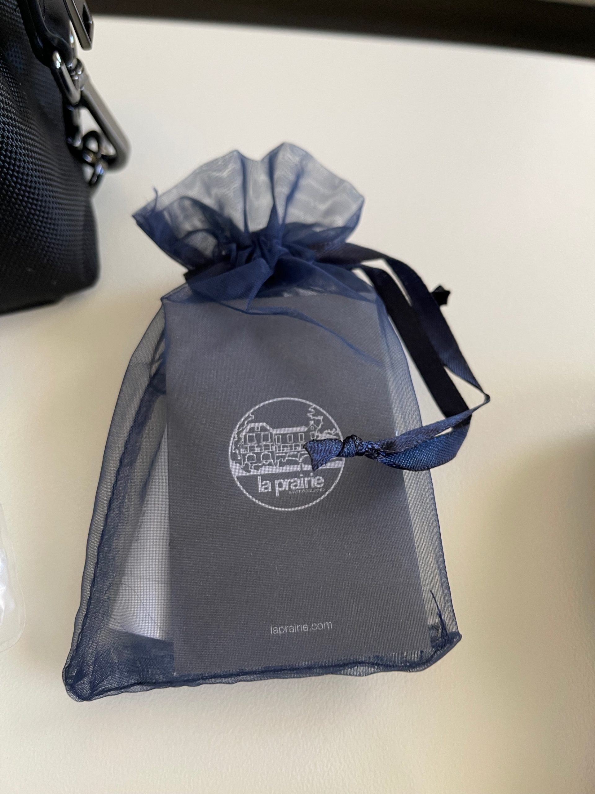 a small blue bag with a blue ribbon