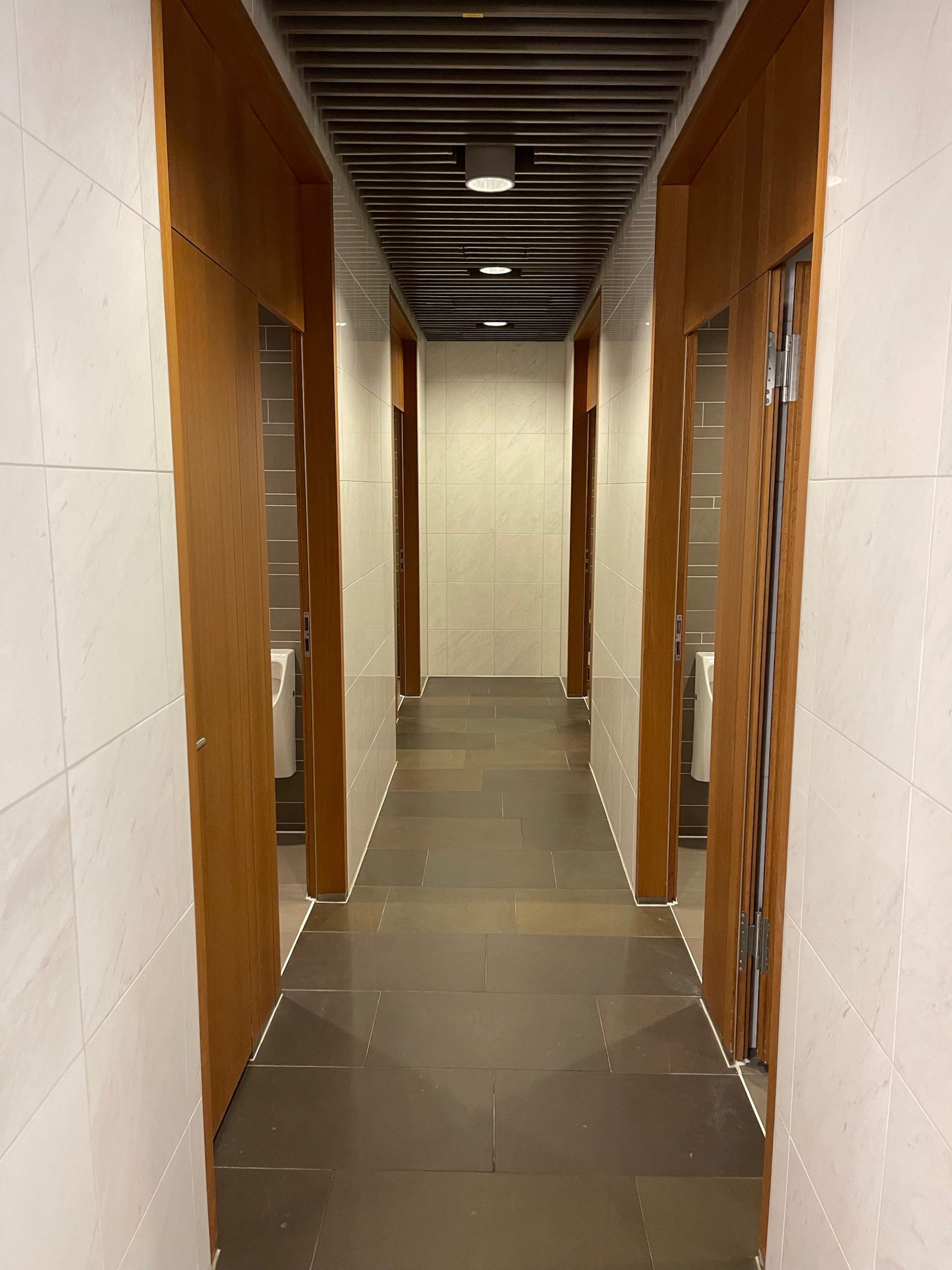 a hallway with doors and a tile floor