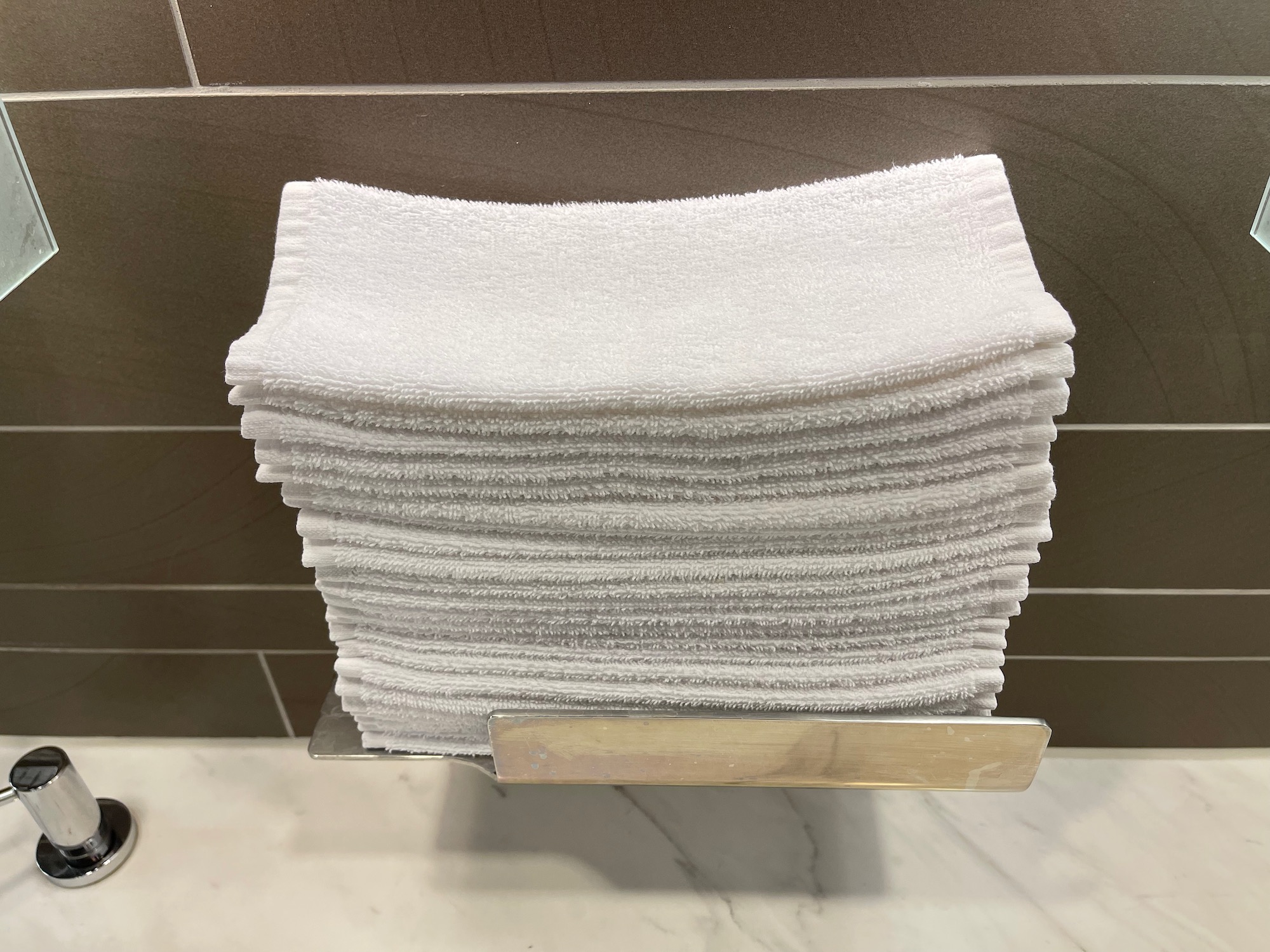 a stack of white towels on a metal holder