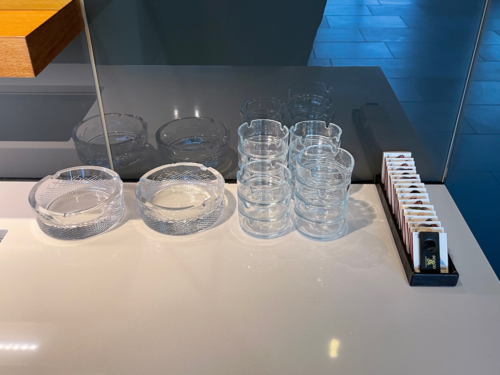 a group of clear glass ashtrays on a table