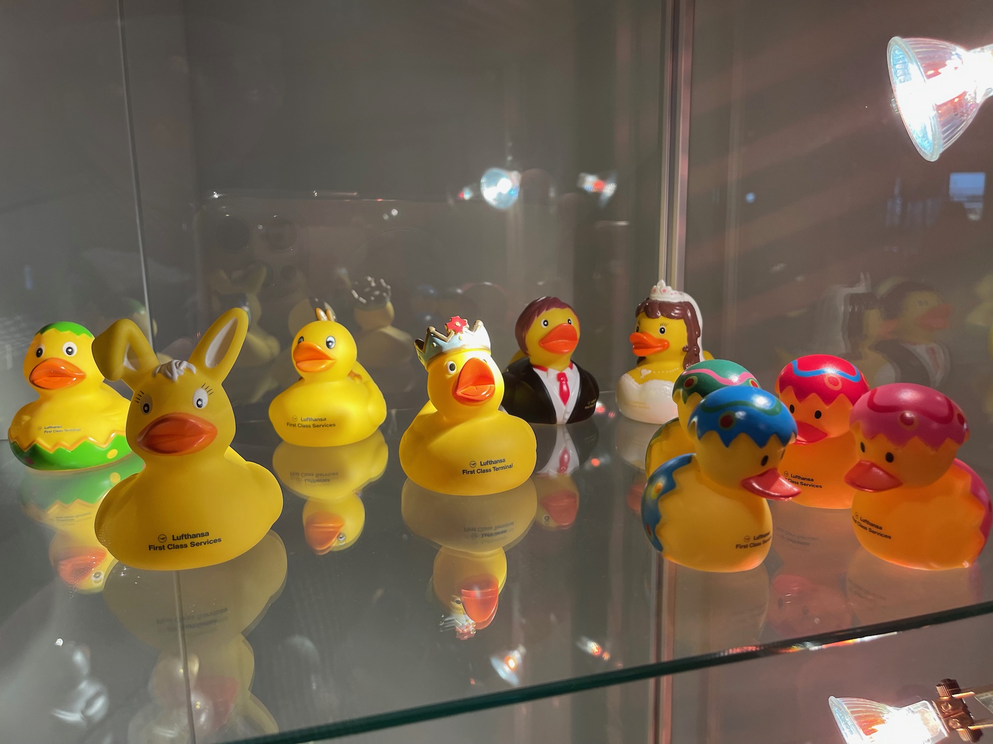 a group of yellow rubber ducks in a glass case