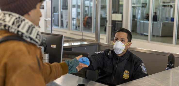 a man wearing a mask and giving a hand to a person