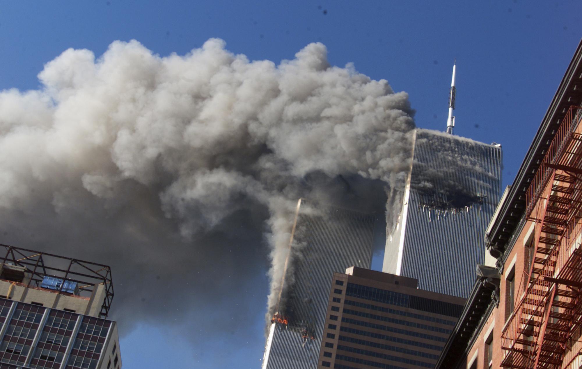 a two towers with smoke coming out of them