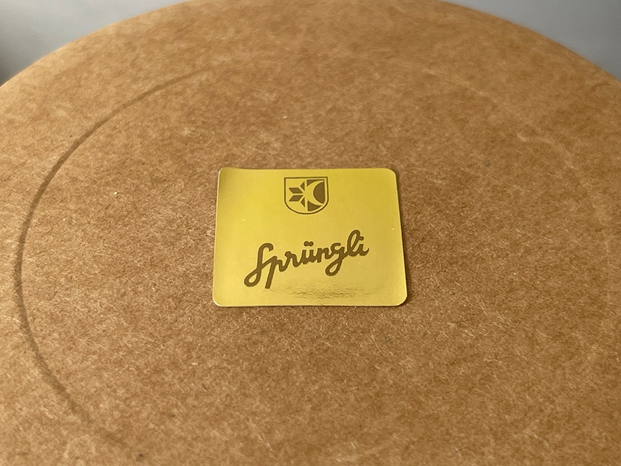 a yellow square sticker on a brown surface