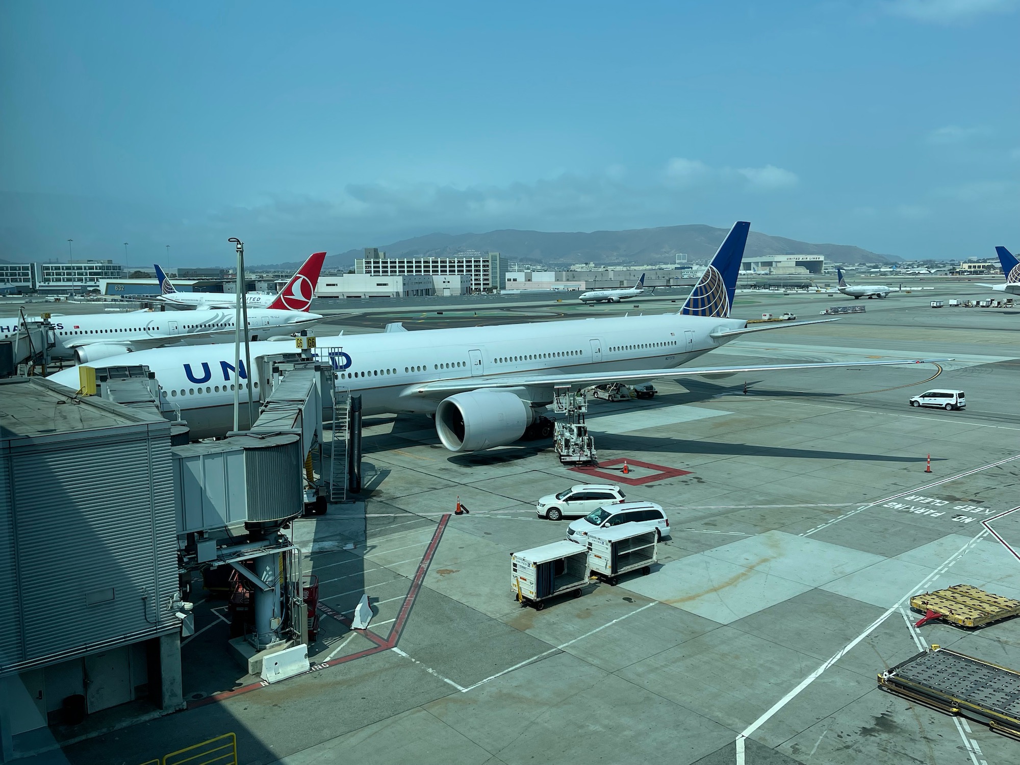 an airport with airplanes and a car