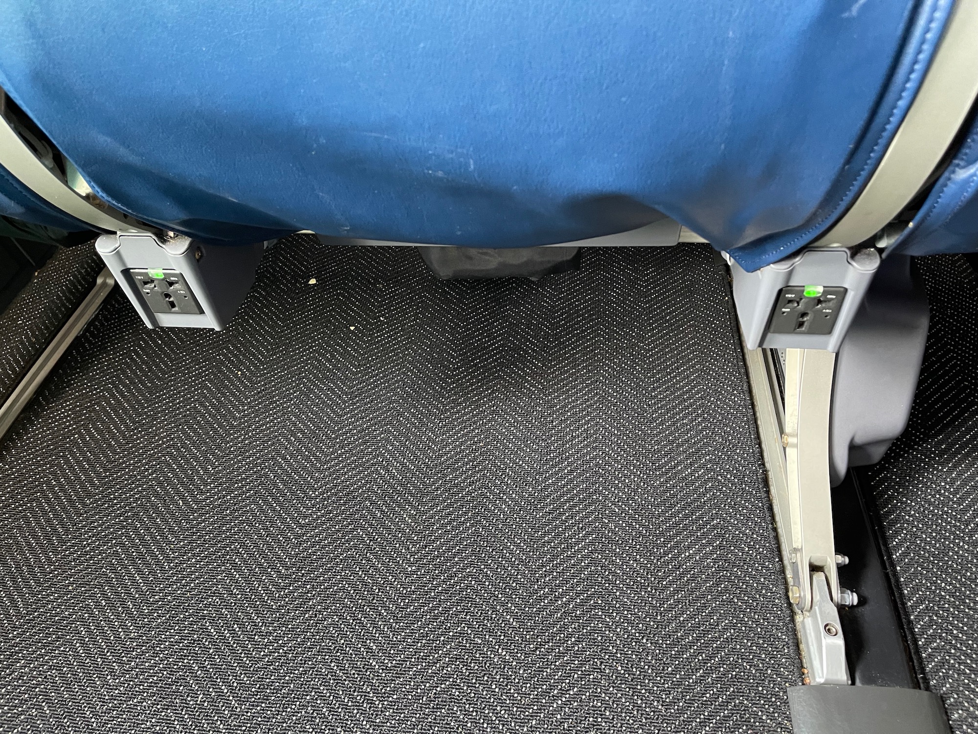 a carpeted floor with electrical outlets