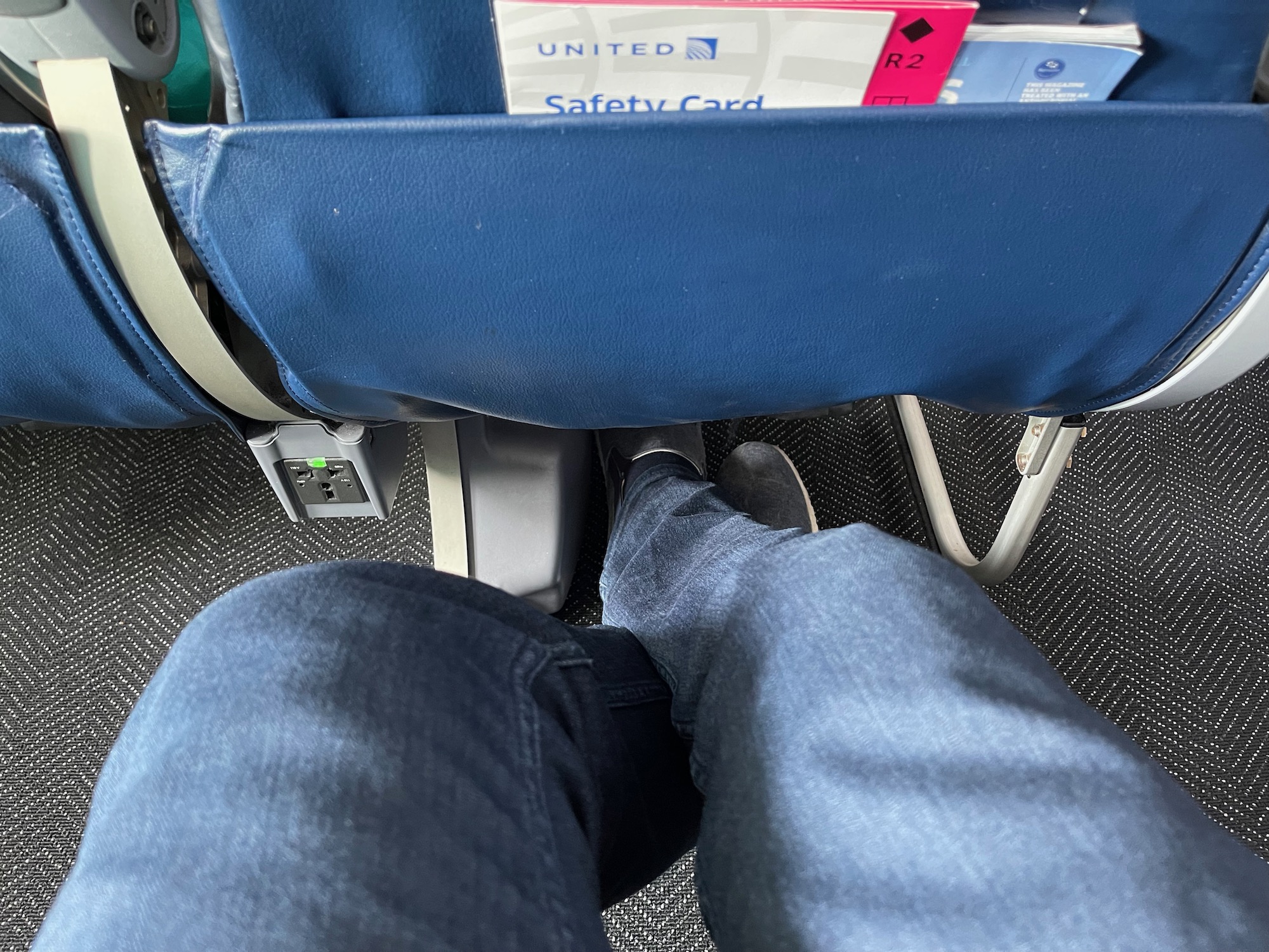 a person's legs and feet in a seat