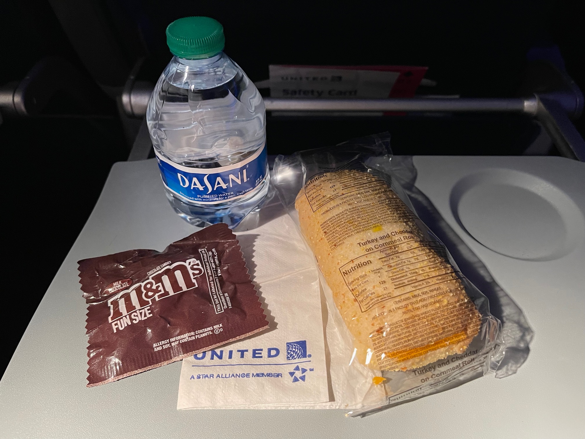 a sandwich and a bottle of water on a table