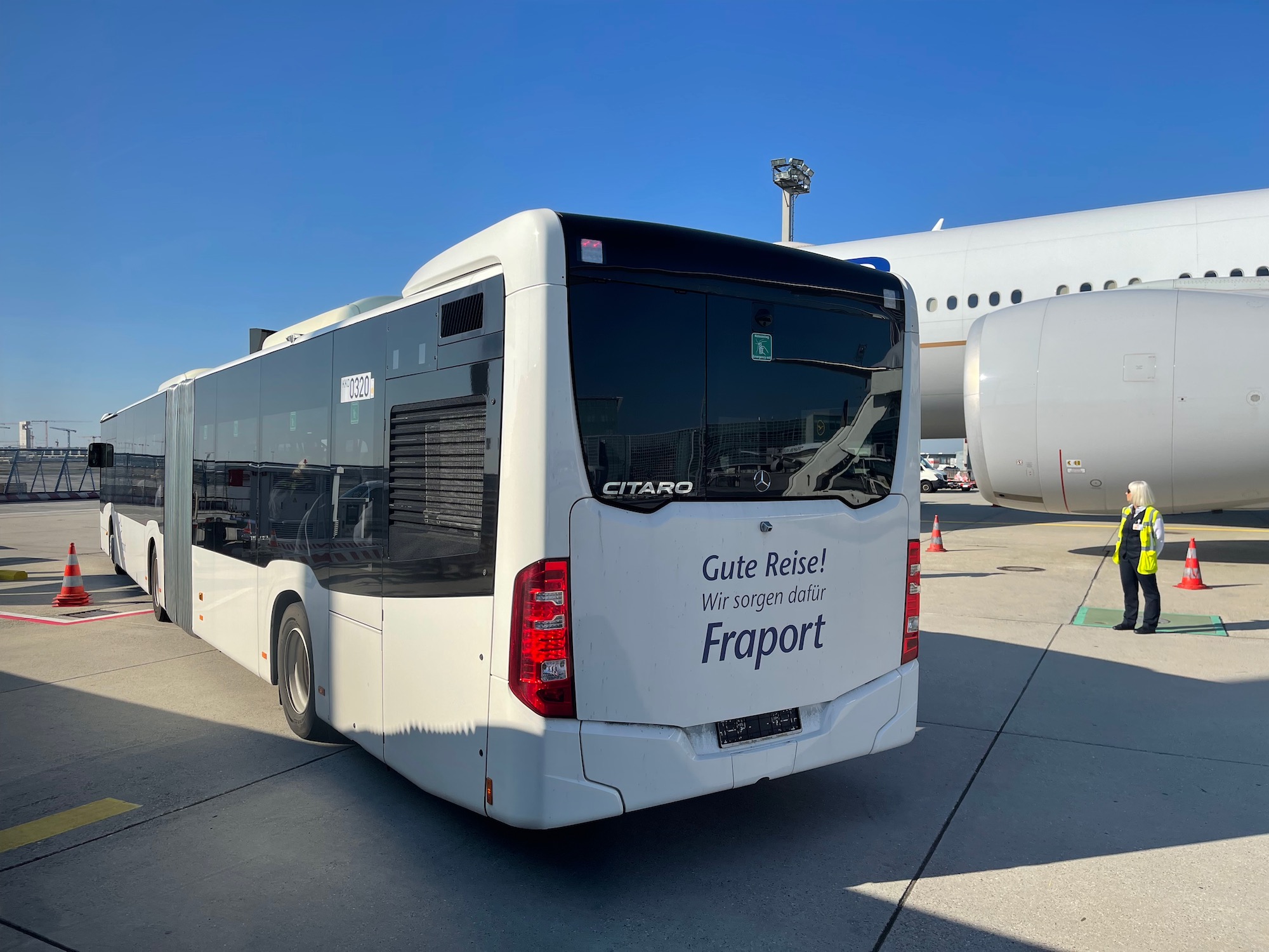 a bus parked in front of an airplane