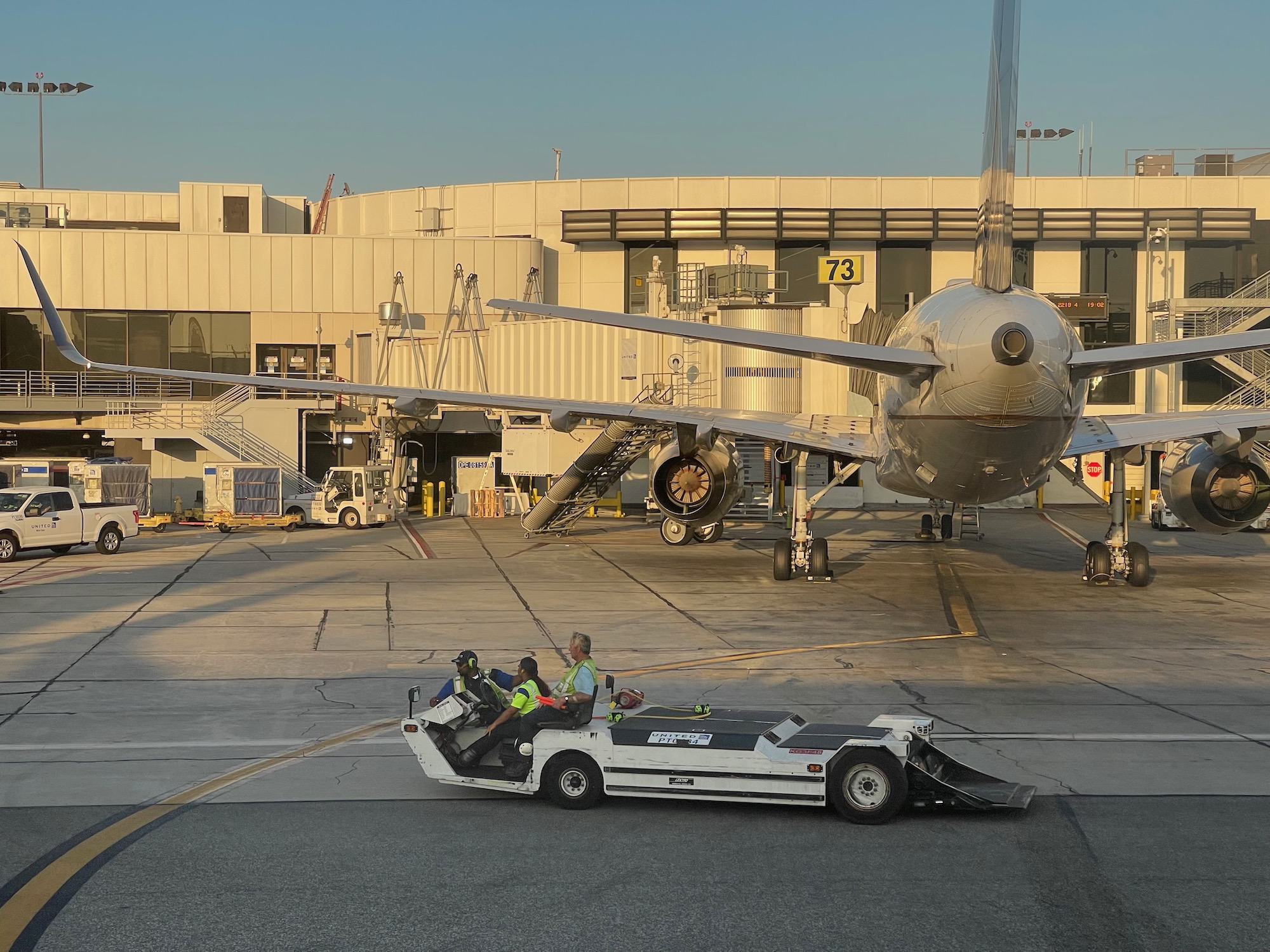 a group of people on a vehicle near an airplane