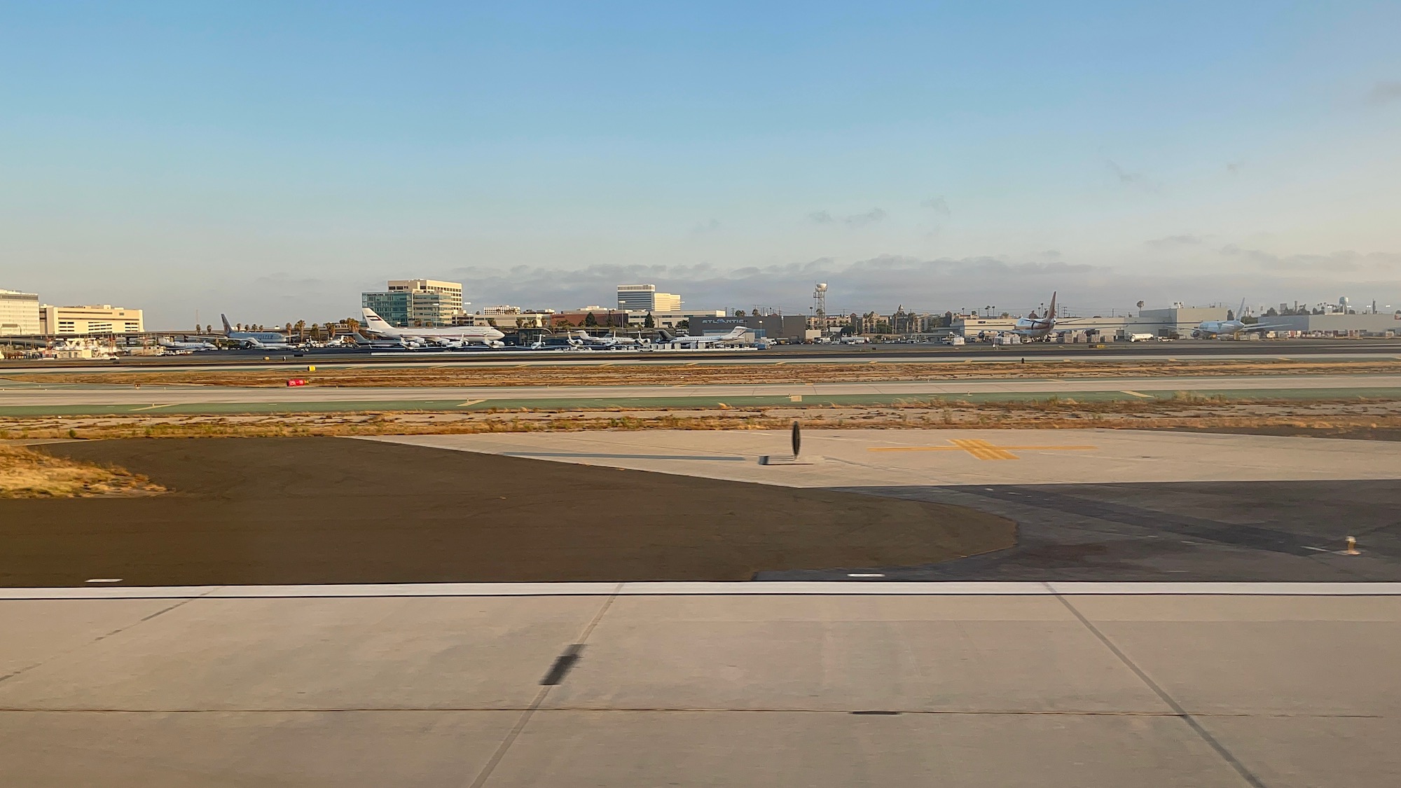 a runway with planes in the background