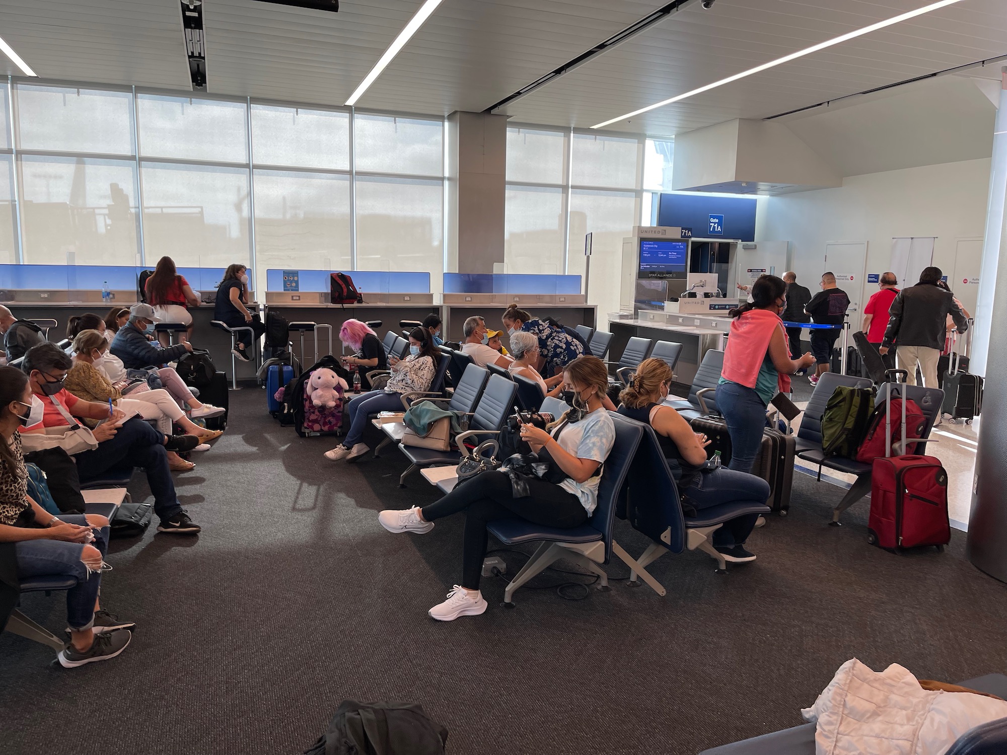 a group of people sitting in chairs in an airport