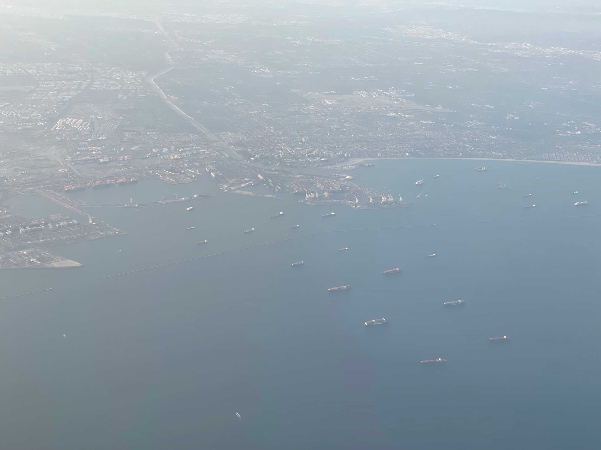 aerial view of a city and ships in the water
