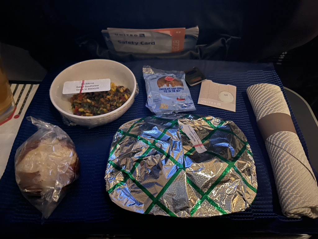 food on a seat with a bag of food