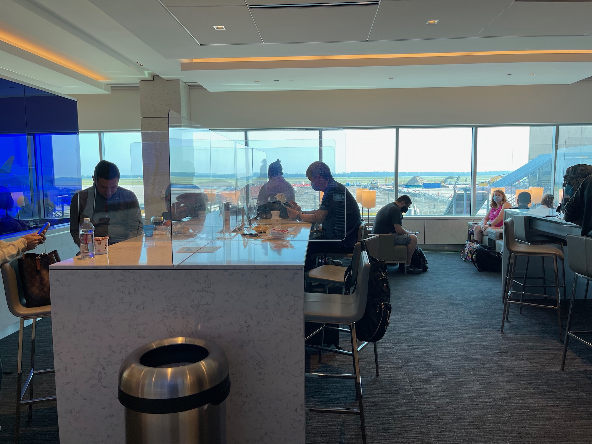 people sitting at a counter in an airport