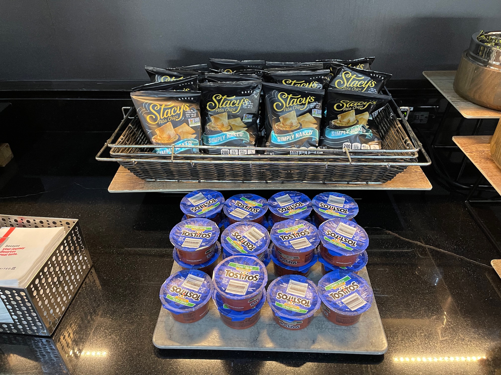 a group of bags of chips and sauces on a tray