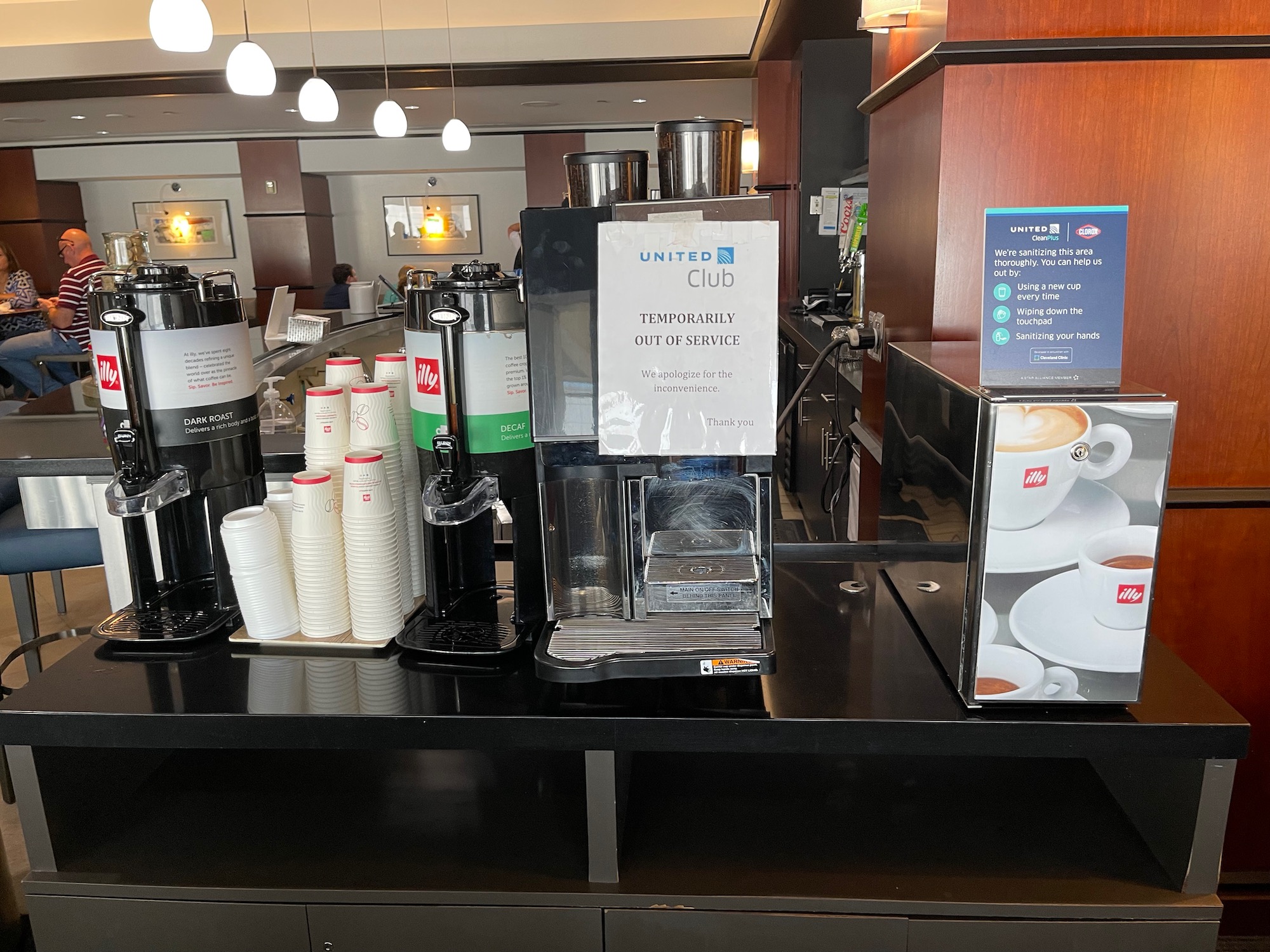 a coffee machine and cups on a counter