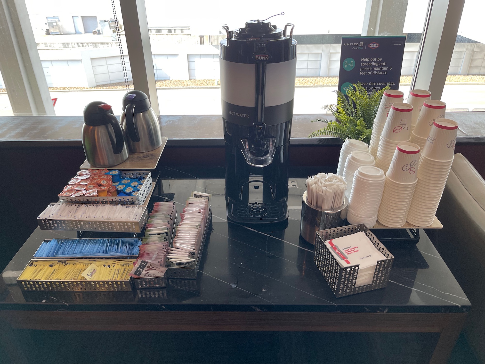 a coffee machine and cups on a table