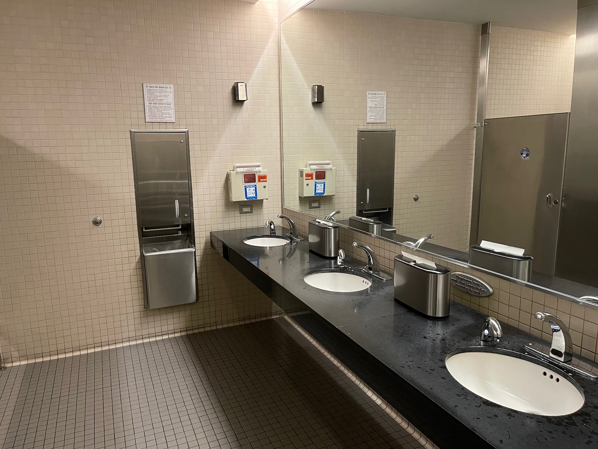 a bathroom with sinks and mirrors