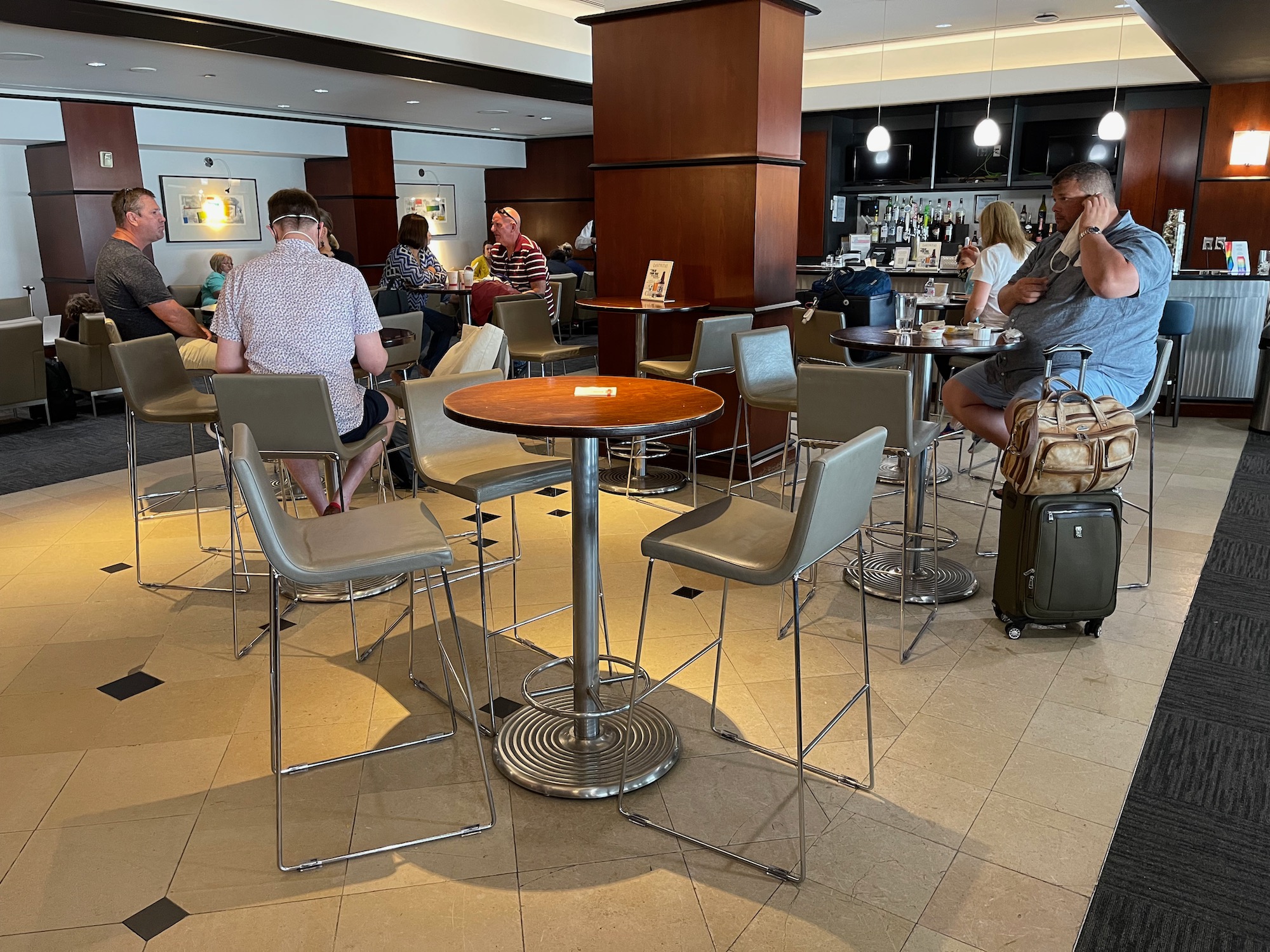 a group of people sitting at tables and chairs