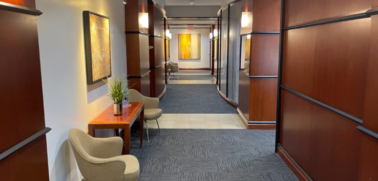 a hallway with chairs and a table