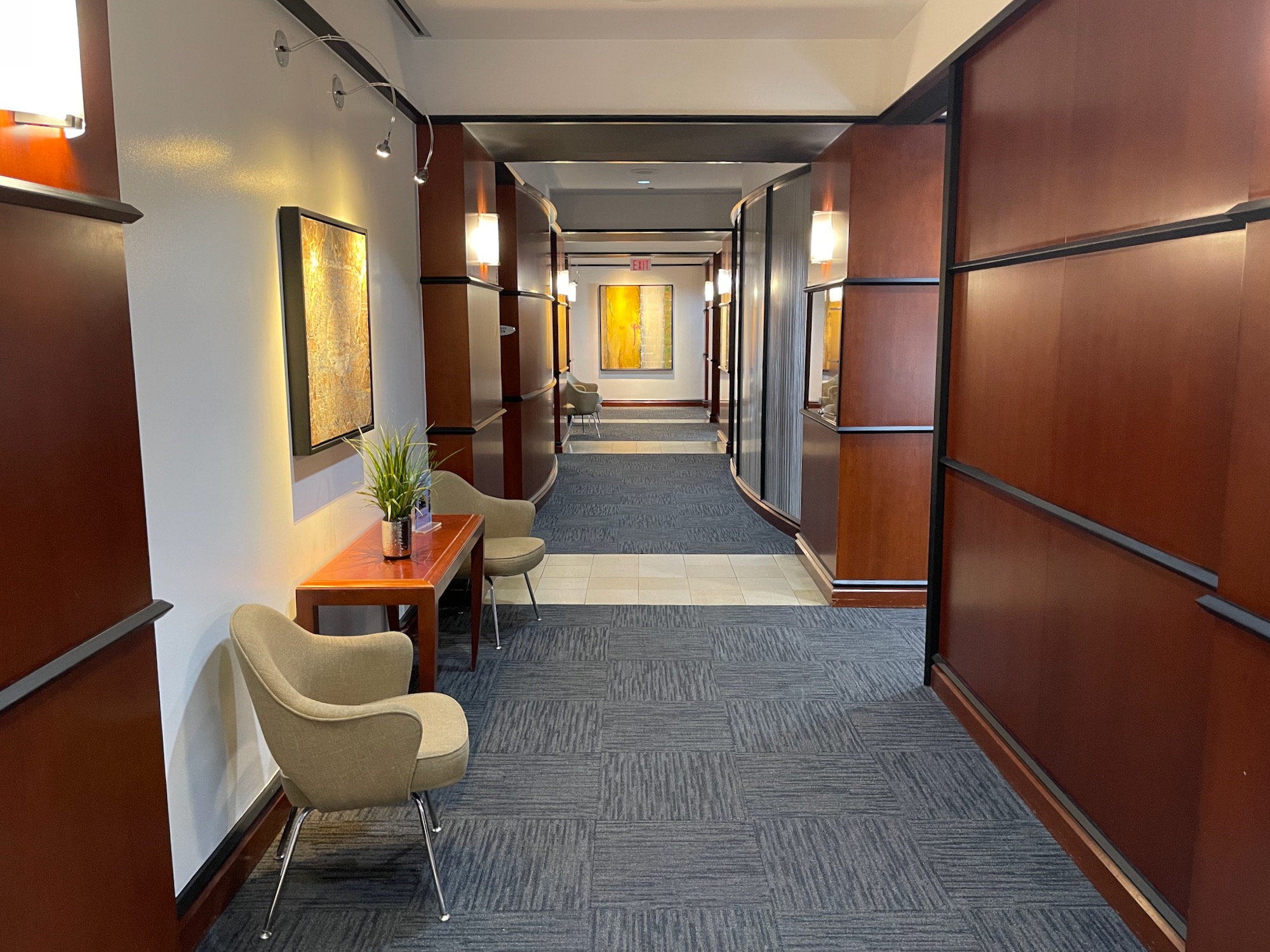 a hallway with chairs and a table