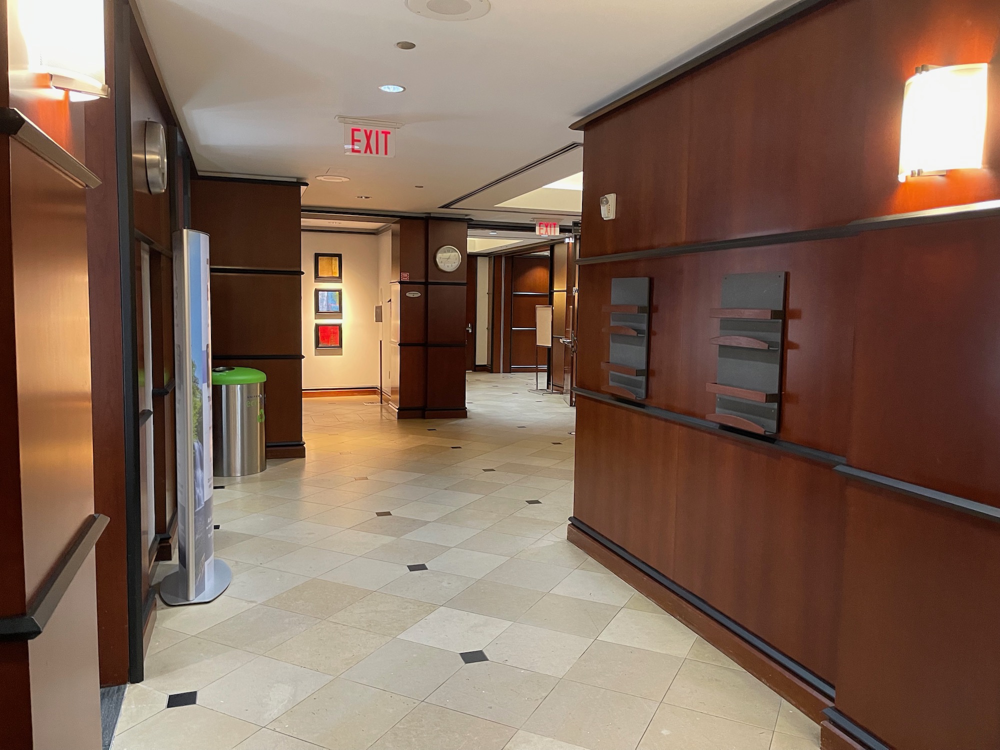 a hallway with wood paneling and a checkered floor