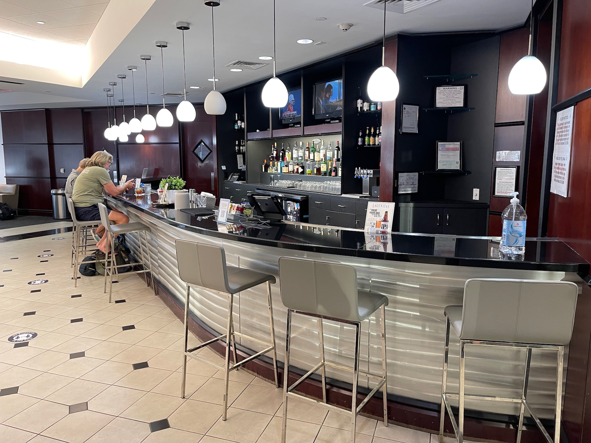 a bar with a counter and chairs