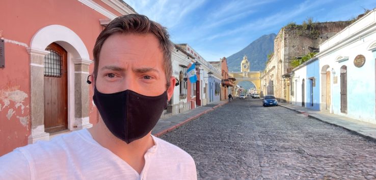 a man wearing a face mask on a street