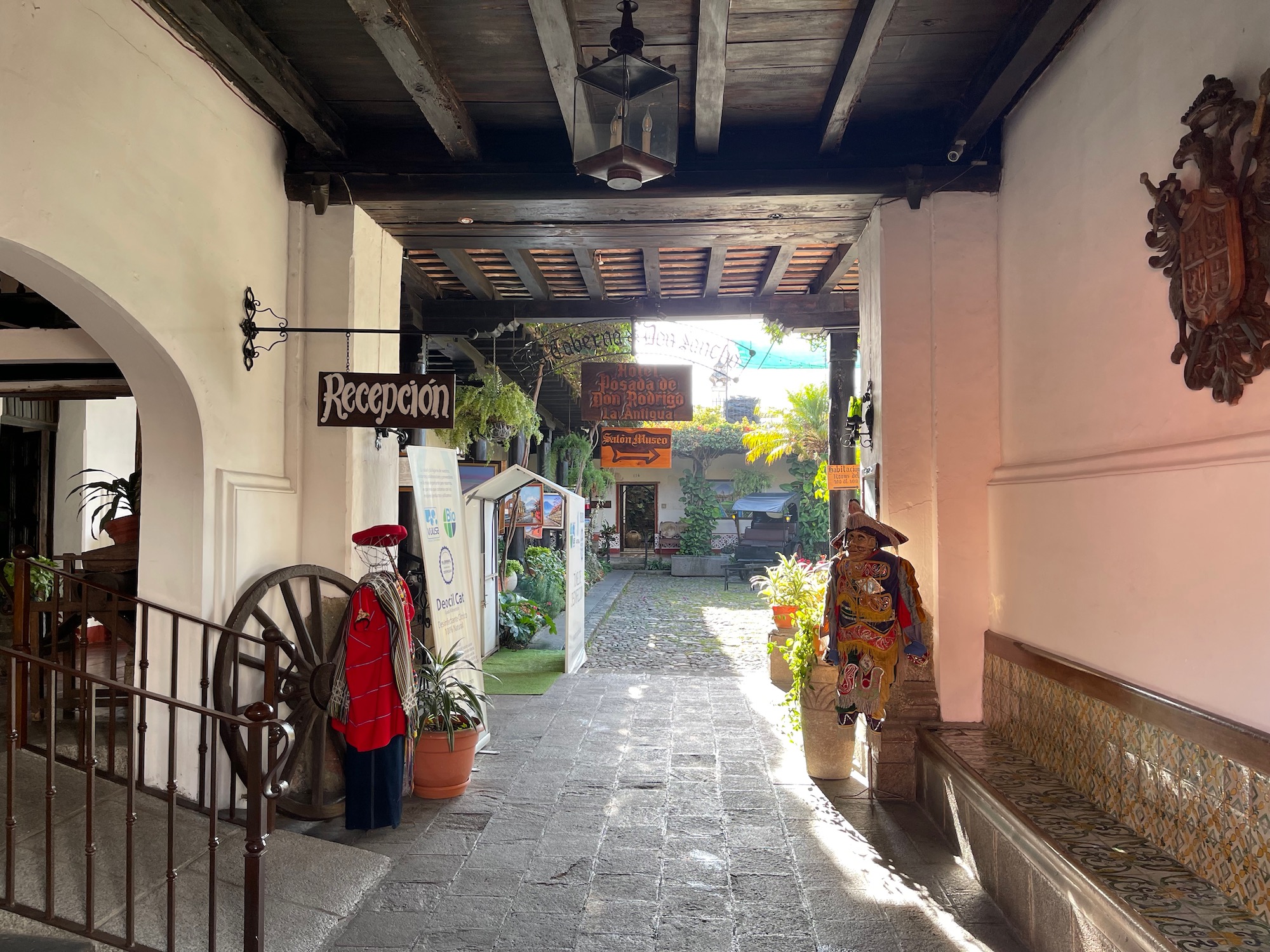 a walkway with a sign and a statue