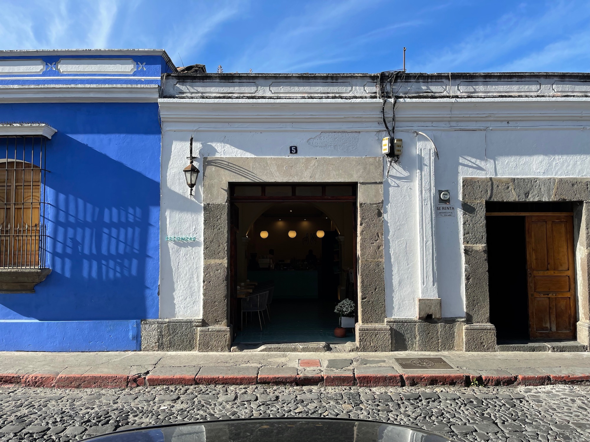 a building with a blue wall and a white wall