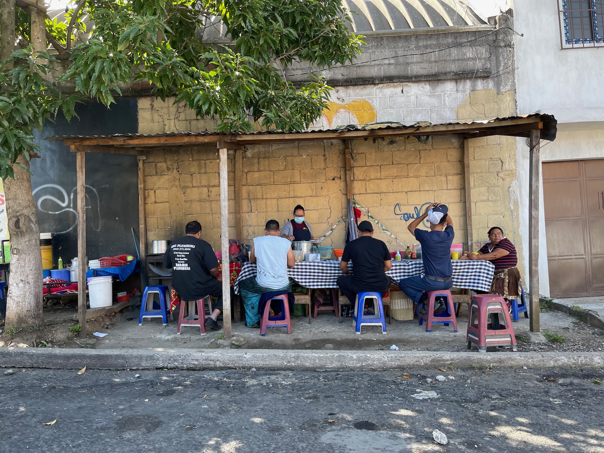 a group of people sitting at a table outside a building