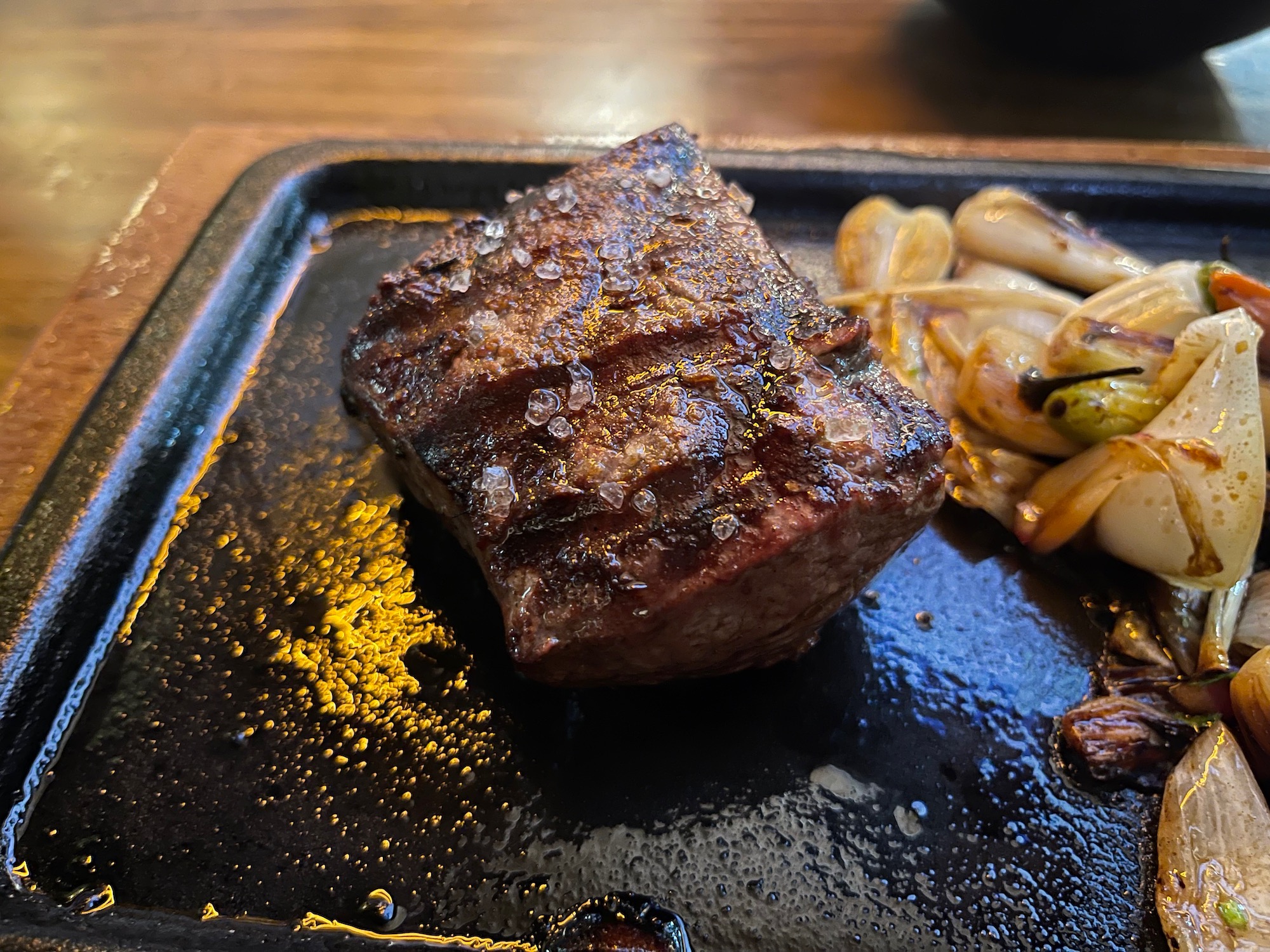 a piece of steak on a black plate