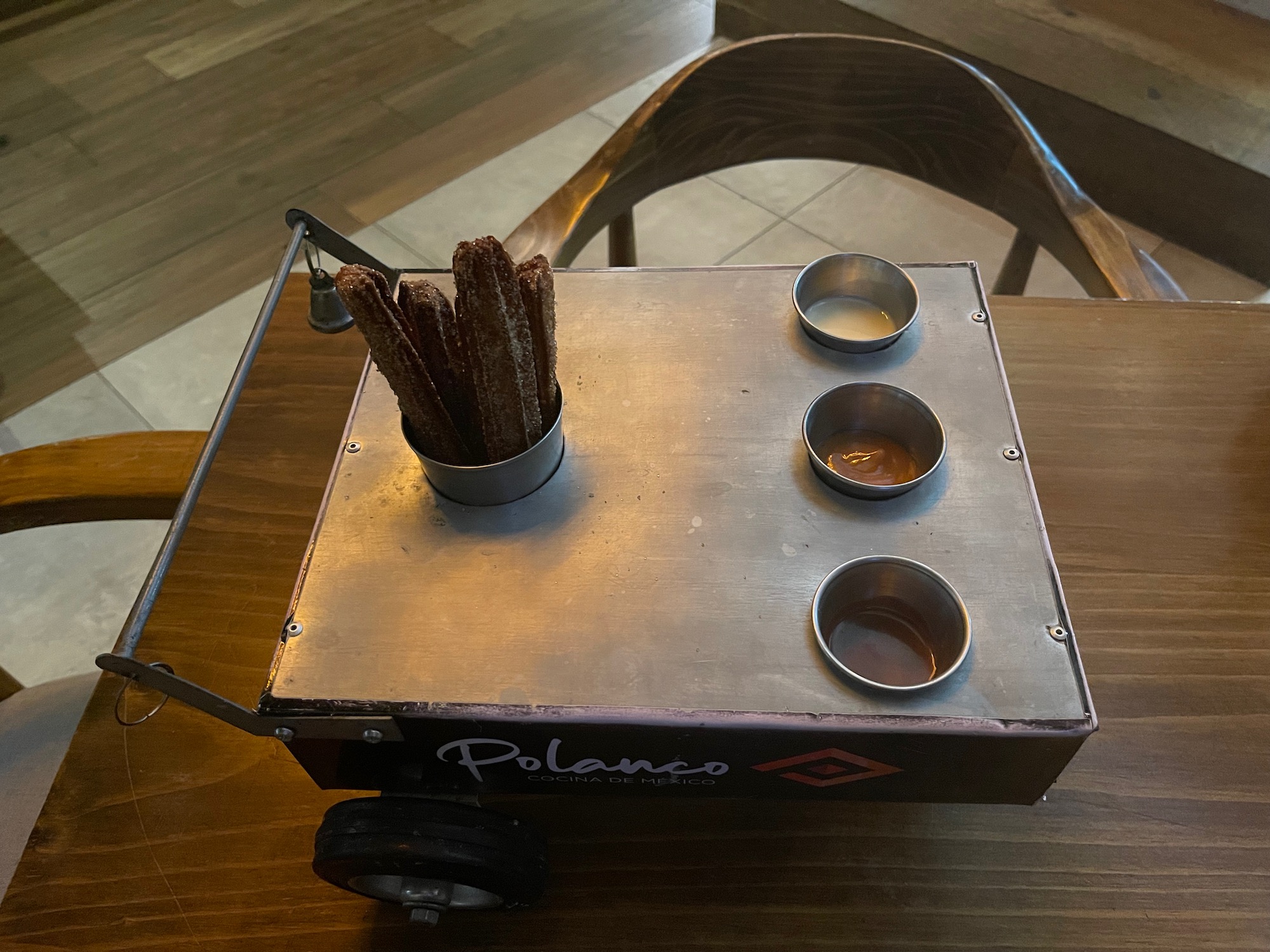 a food cart with a few cups and a few small bowls on a table