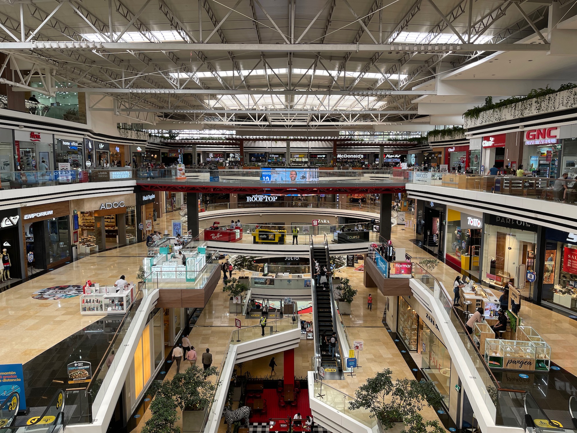 a large mall with many floors and people walking