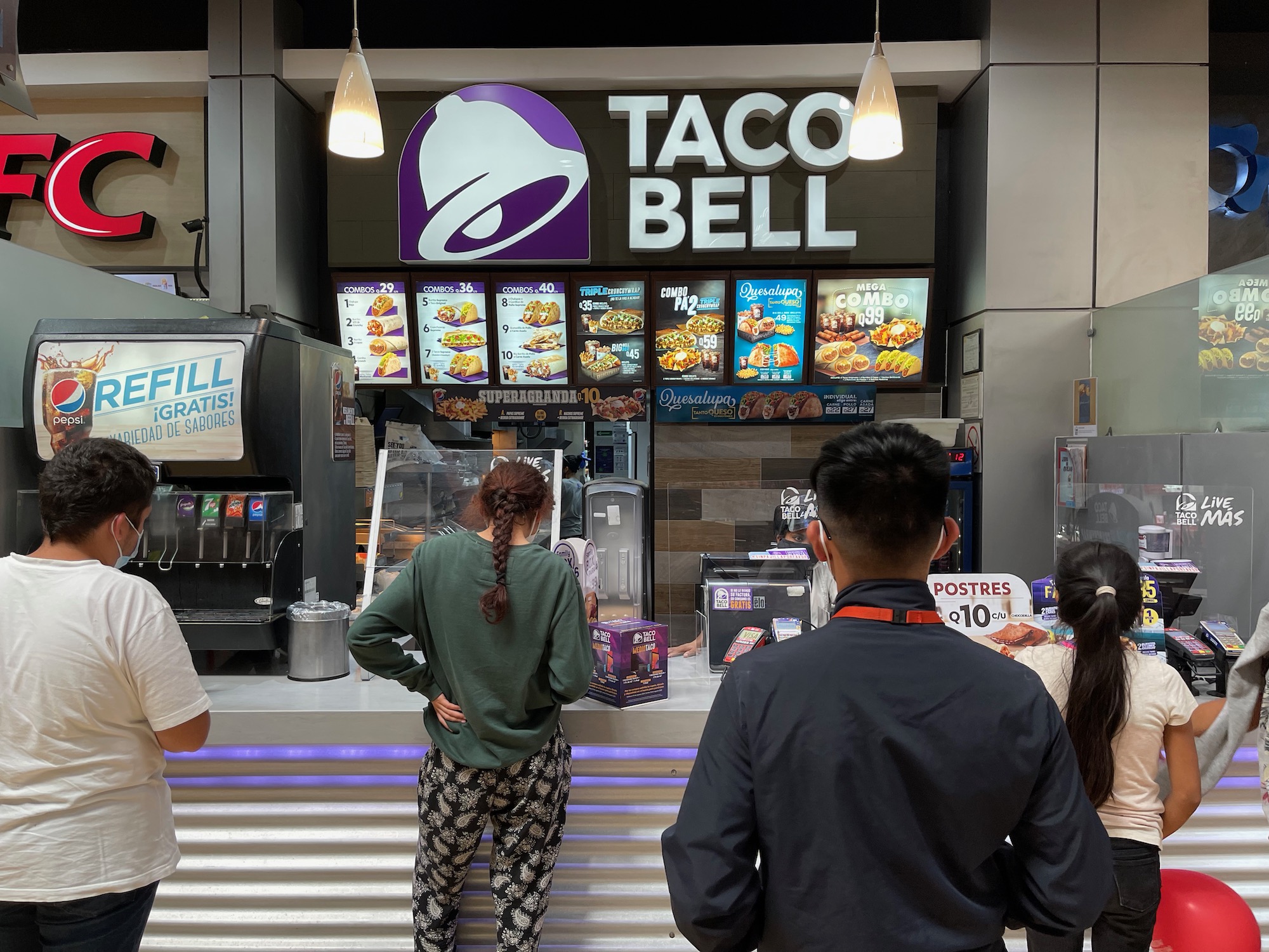 people standing in front of a food stand